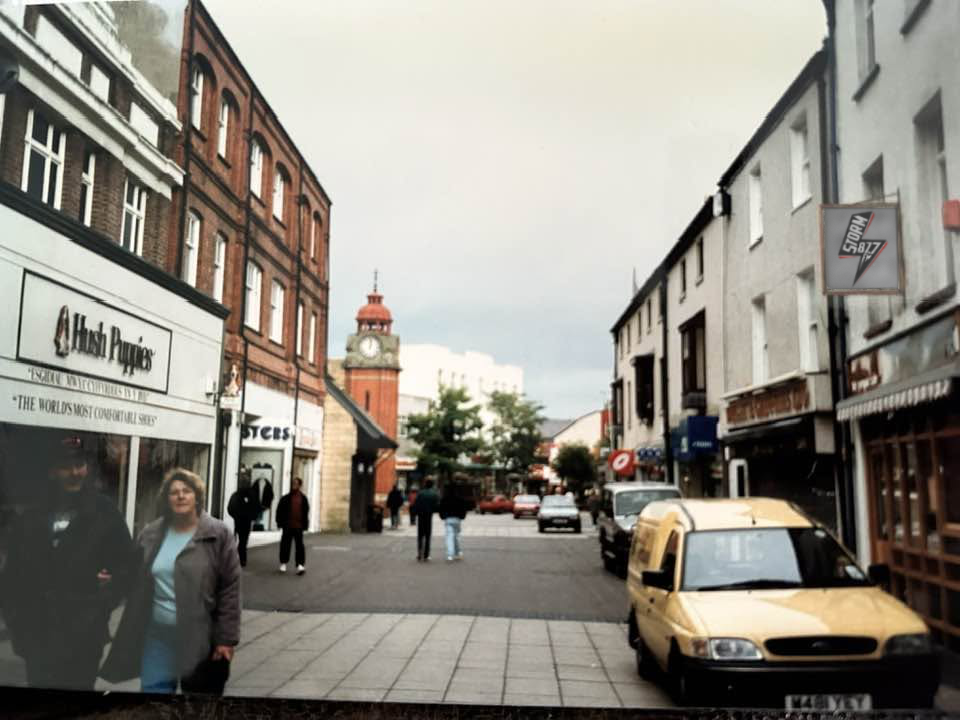 Photograph of High Street, Bangor in the late 1990s. The Storm FM logo is on a sign over a shop.